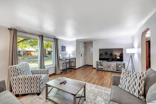 a living room with a couch and a table at Gorgeous 3 bedroom home, minutes from Lambeau! in Green Bay