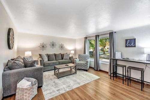 a living room with a couch and a table at Gorgeous 3 bedroom home, minutes from Lambeau! in Green Bay