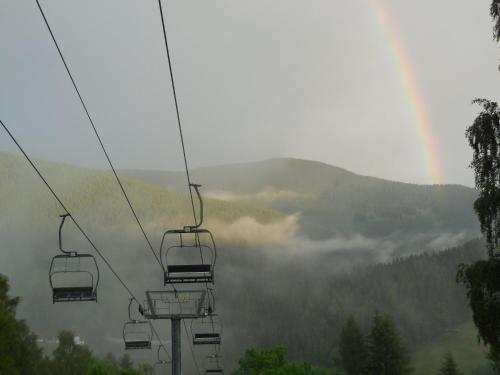 a gondola ride in the mountains with fog in the valley at Penzion Alenka in Špindlerův Mlýn