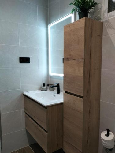 a bathroom with a sink and a mirror at Apartamento Verdemare in Corralejo