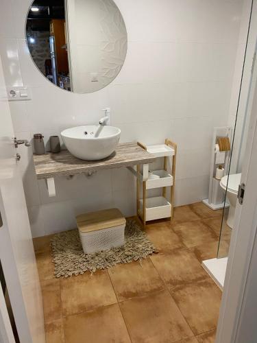 a bathroom with a sink and a mirror at Carballo Alenza in Sistín