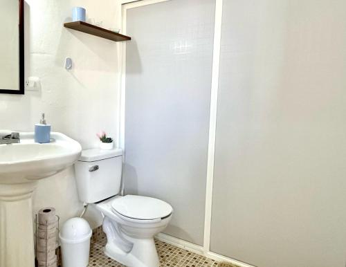 a white bathroom with a toilet and a sink at Perfect Place Cozumel - DIANA in Cozumel