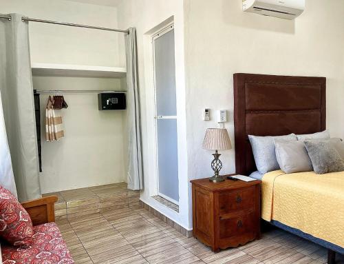 a bedroom with a bed and a lamp on a table at Perfect Place Cozumel - DIANA in Cozumel