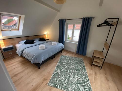 une chambre avec un lit et une grande fenêtre dans l'établissement Appartement Au Sommet du Ruisseau, à Niederbronn-les-Bains