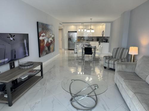 a living room with a couch and a table at Trendy 1BD Condo 4 Mins to Beach in Sunny Isles Beach