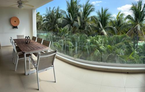 a dining room with a table and a large window at Apartment in Playa del Carmen with Private Beach in Playa del Carmen