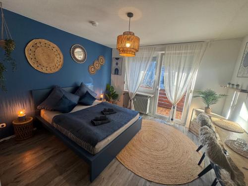 a bedroom with a bed and a blue wall at BOHO Apartment Zirbe Blue in Bad Reichenhall