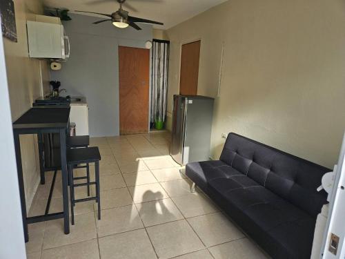 a living room with a couch and a kitchen at Terrace with Jacuzzi Modern 2 in San Juan