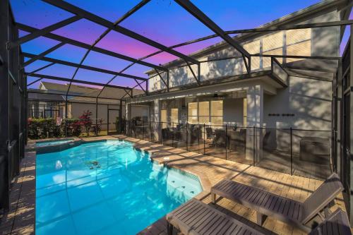 an indoor swimming pool with a glass roof at Getaway Cove Villa in Orlando