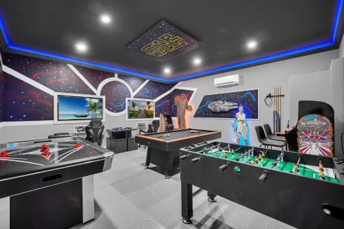 a gaming room with two tables and a pool table at Getaway Cove Villa in Orlando
