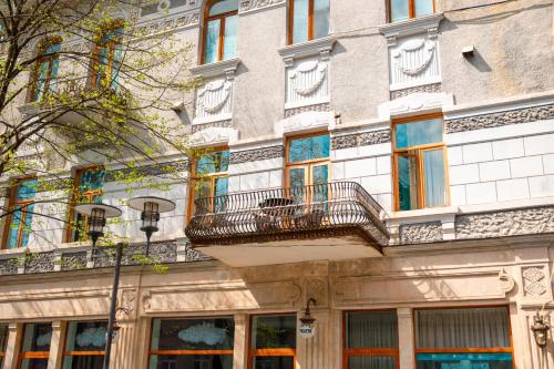 a building with balconies on the side of it at Belona Hotel in Kutaisi
