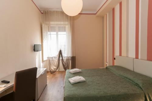 Postel nebo postele na pokoji v ubytování Nonna Adriana