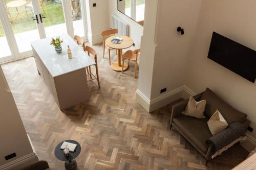 a living room with a couch and a table at FiveM West Hampstead - South in London