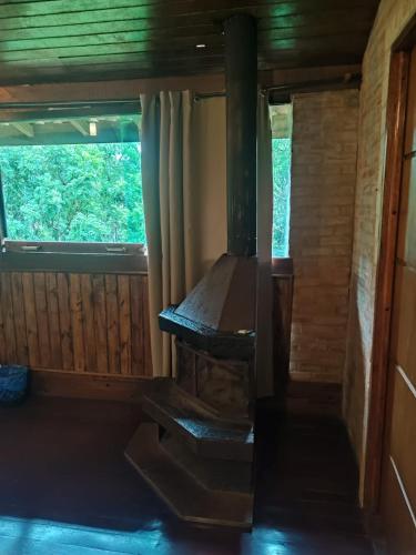 an inside view of a cabin with a woodburning stove at Pássaro de Fogo in Santo Antônio do Pinhal