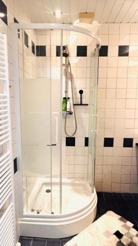 a shower with a glass door in a bathroom at Light and Spacious Getaway House in Arnhem