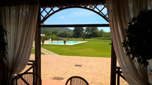 a view of a swimming pool through a window at Il Casale di Riardo Luxury B&B in Riardo