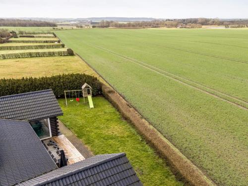 an aerial view of a field and a house at Luxury Lodge with Limfjord View - By Traum Ferienwohnungen in Spottrup