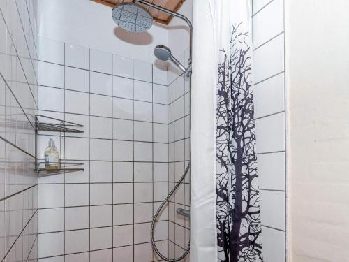 a bathroom with a shower with a plant on the wall at Luxury Lodge with Limfjord View - By Traum Ferienwohnungen in Spottrup