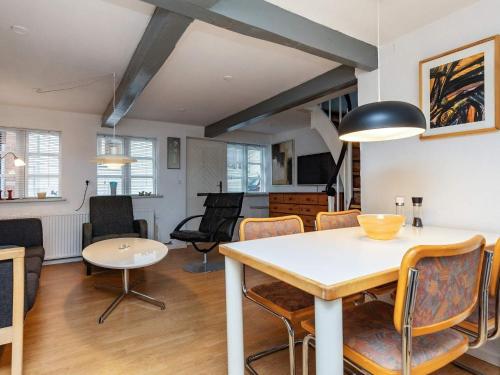 a dining room and living room with a table and chairs at 4 person holiday home in Rudkøbing-By Traum in Rudkøbing
