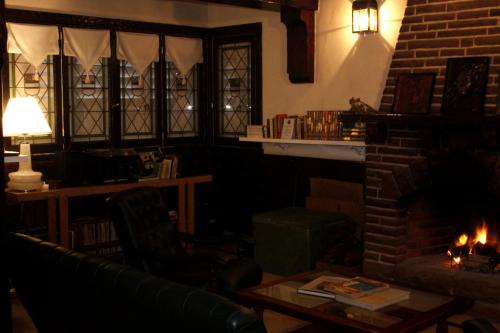 a living room with a fireplace and a couch at Hotel Medina y Mar BnB in Mar del Plata