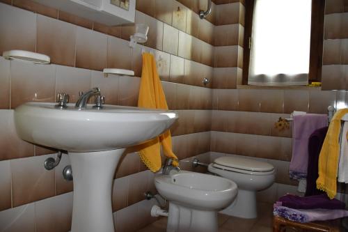 a bathroom with a sink and a toilet at Lacona in Lacona