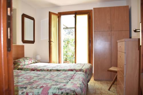 a bedroom with a bed and a dresser and a window at Lacona in Lacona
