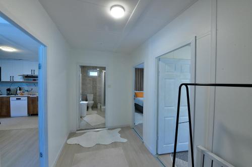 a white room with a mirror and a kitchen at İZNİK Lake Olive villa in İznik
