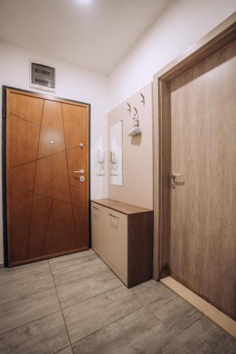 a room with a closet and a wooden door at Darki Apartments 3 - Very Central Stay With Free Parking in Ohrid