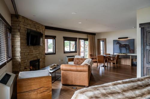 a living room with a couch and a fireplace at The Estes Park Resort in Estes Park