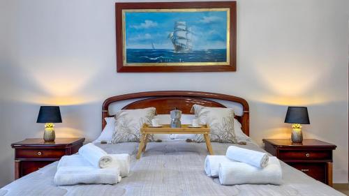 a bedroom with a bed with a table on it at La Dimora del Cavaliere - Stupenda Dimora a 5 Min Dal Lago di Martignano in Anguillara Sabazia