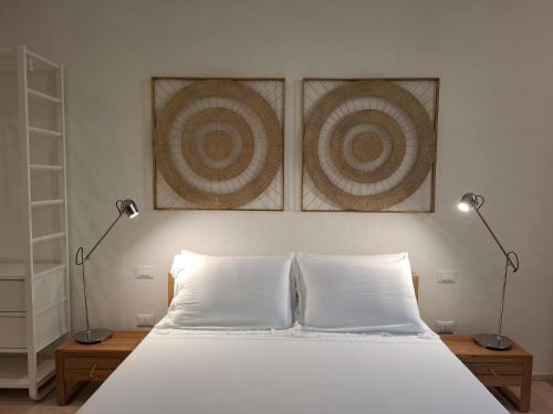a bedroom with a bed with two lamps on it at Fuga romantica e di relax in Martano