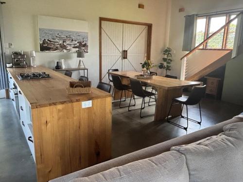 a kitchen with a table and a table and chairs at The Shed at Beechwood in Beechwood