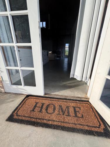 a welcome mat in the doorway of a house at The Shed at Beechwood in Beechwood