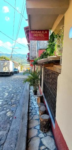 a hotel with a sign on the side of a street at Hotel Rosalila in Copan Ruinas