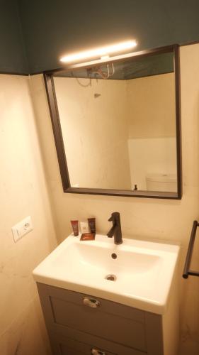 a bathroom sink with a large mirror above it at Il Vicoletto B&B in Cirò Marina