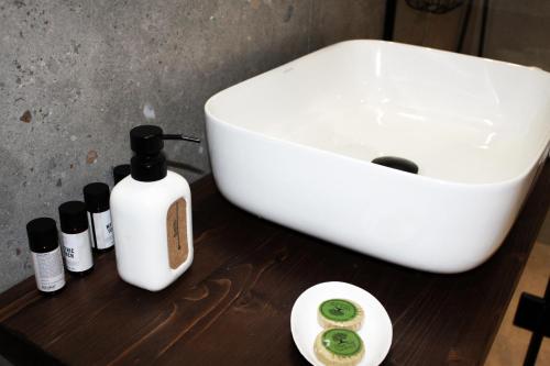 a white sink and some bottles on a wooden table at Art Studios Gialova Navarino in Gialova