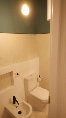 a bathroom with a white toilet and a sink at Il Vicoletto B&B in Cirò Marina