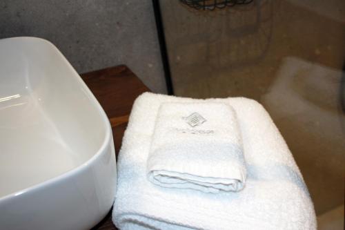 a pile of towels on a counter next to a sink at Art Studios Gialova Navarino in Gialova