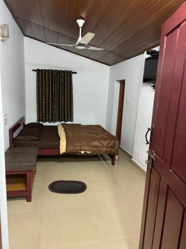 Ένα ή περισσότερα κρεβάτια σε δωμάτιο στο Westernghats Homestay