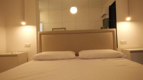 a bed with two pillows on it in a room at Il Vicoletto B&B in Cirò Marina