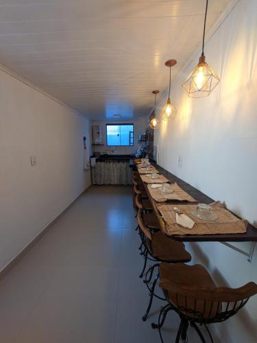 a long row of tables and chairs in a room at Hospedagem Tiradentes - Centro in Tiradentes