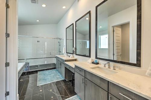 a bathroom with two sinks and two mirrors at Agave Luxe Home - 8 Mi to Downtown in Austin