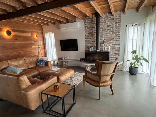 a living room with a couch and a table at The Shed at Beechwood in Beechwood