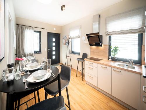 a kitchen and dining room with a table and chairs at Schneerose in Maria Alm am Steinernen Meer