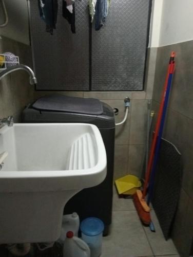 a small bathroom with a toilet and a sink at Spacious Apartment - Los Olivos in Lima