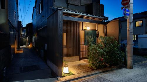 a building with a light on the side of a street at Kyoto Ayanishiki Shimabara-Omon Residence in Kyoto