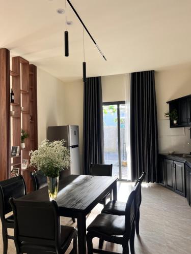 a kitchen and dining room with a table and chairs at Jun Home - Dalat in Da Thanh