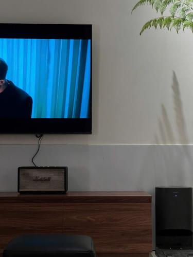 a flat screen tv sitting on a white wall at Jun Home - Dalat in Da Thanh