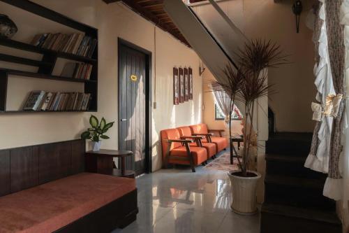 a living room with a couch and a chair at Hạ Hoàng Hôn House & Coffee in Da Lat