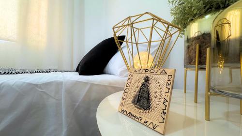 a vase sitting on a table next to a bed at Casa em Aparecida 300m2 próximo ao Santuário Nacional in Aparecida